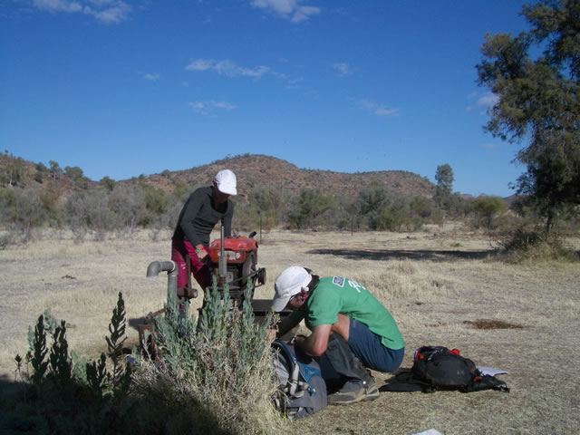 Filling our water bladders from a hand pump!